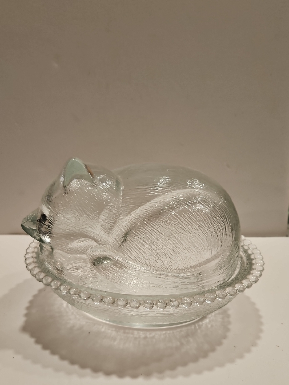 INDIANA GLASS SLEEPING KITTEN ON A NEST CRYSTAL COVERED BEADED DISH.